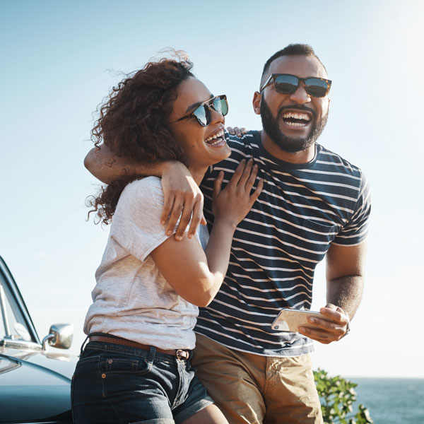 couple smiling while on a road trip together