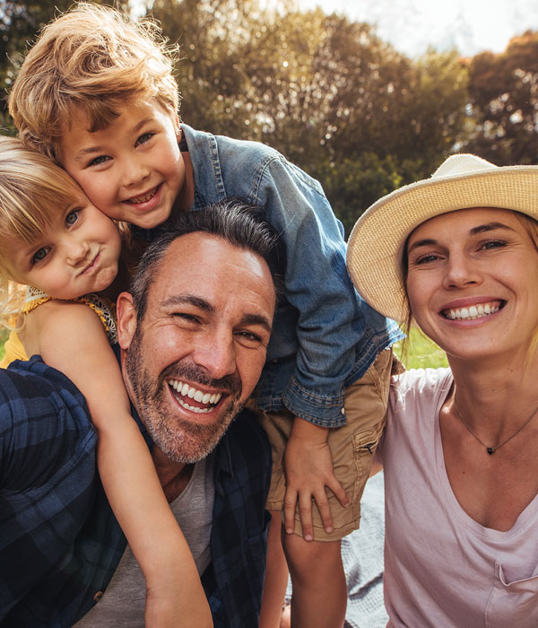 family of four smiling together