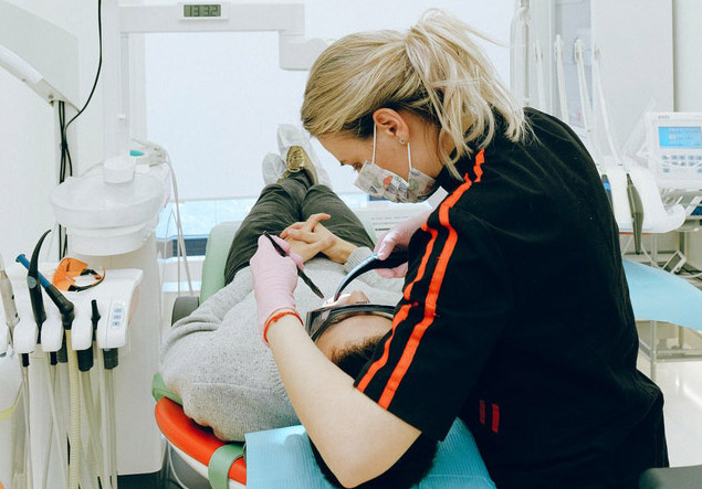 Dentist cleaning a patients teeth